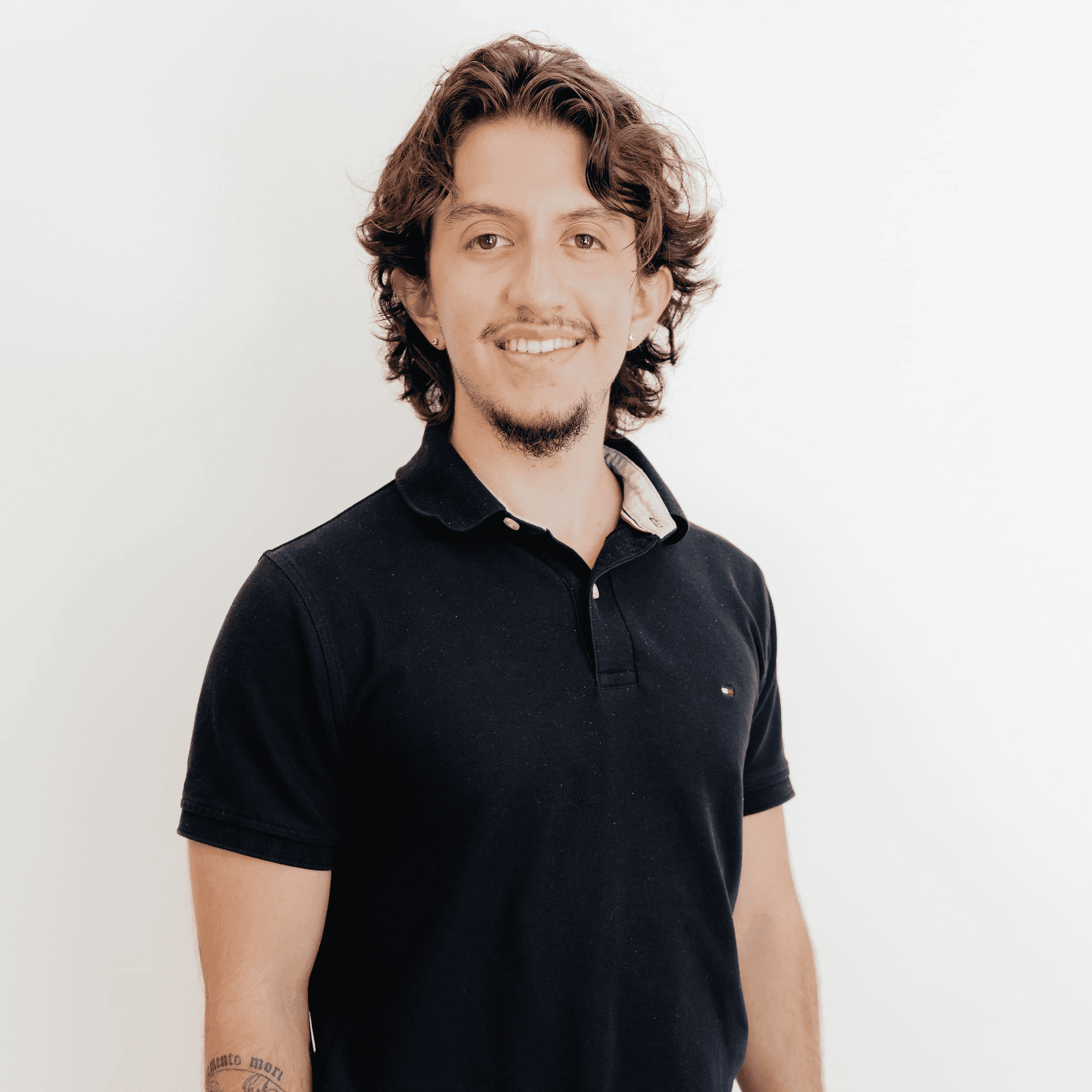 Portrait of Nick Andrade, a professional stylist at Flying Scissors Salon & Spa, showcasing their expertise and style.